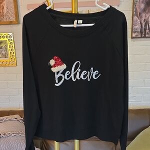 Black 'Believe' Sweatshirt with Santa Hat Design